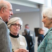Three people speaking to each other at the event.